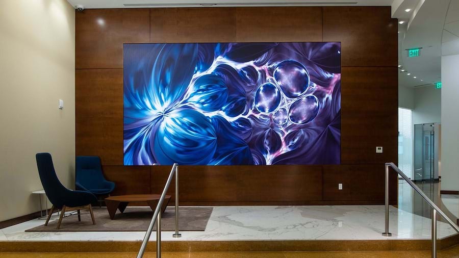 A video wall can welcome guests to an office as a dynamic piece of artwork.